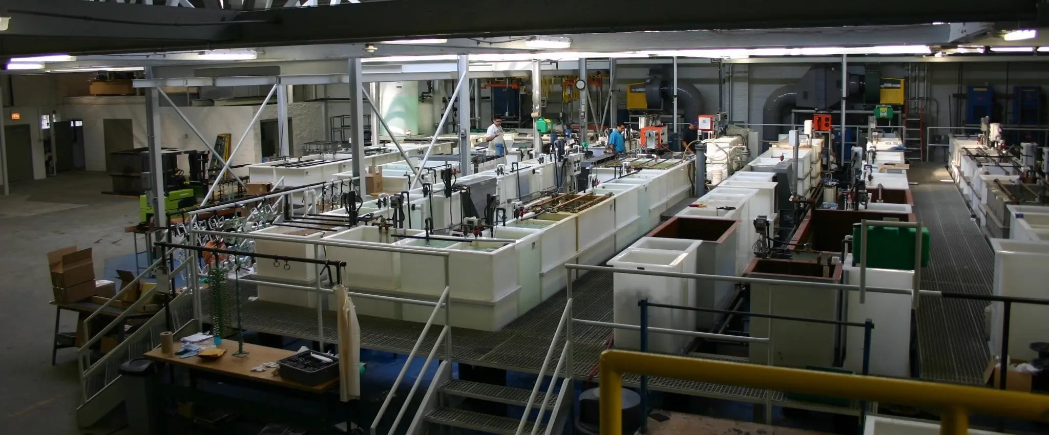 Industrial electroplating lines and tank rows